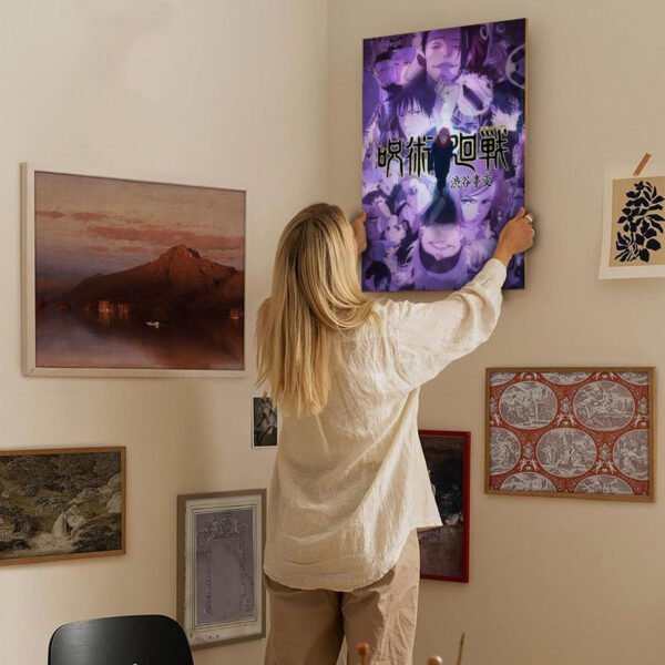 Person hanging Jujutsu Kaisen Shibuya Incident poster on gallery wall surrounded by framed artwork in home interior.