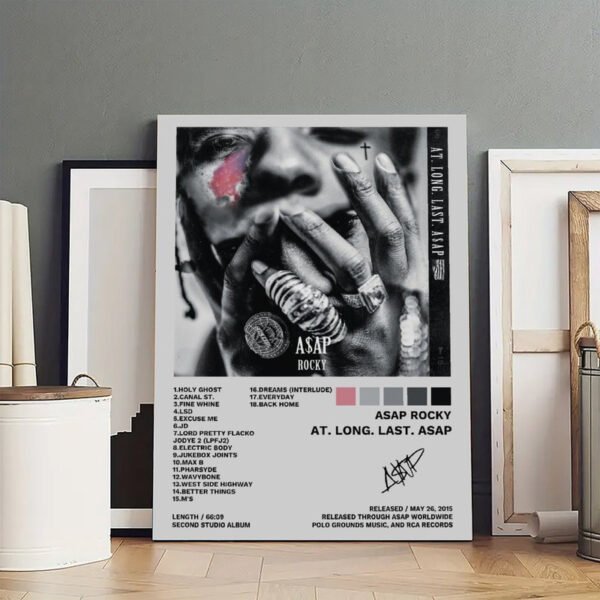 Framed A$AP Rocky AT. LONG. LAST. A$AP album poster with complete 18-track listing displayed in modern minimalist interior setting with wooden floors and neutral decor.