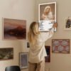 Person hanging Billie Eilish HAPPIER THAN EVER poster on eclectic gallery wall for home decor styling
