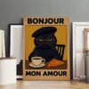 "Bonjour Mon Amour" French cat poster featuring black cat with beret and glasses at café table, displayed in studio setting with empty frames for size reference.