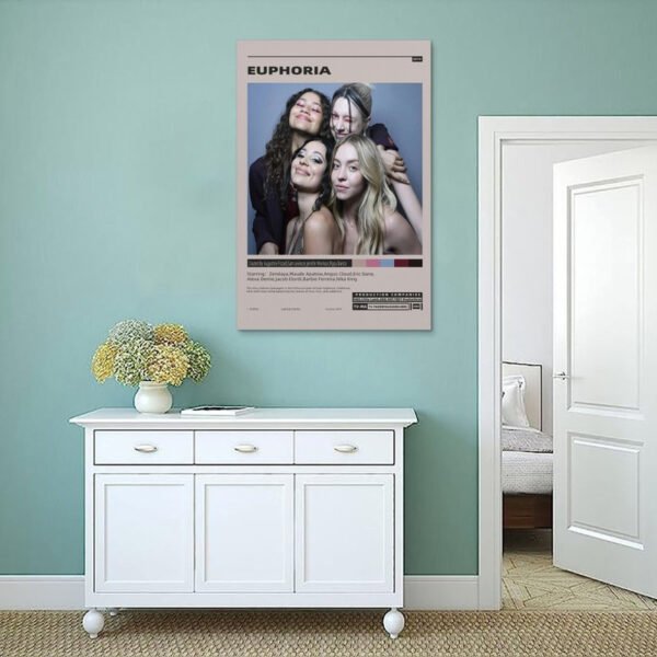 Euphoria HBO poster displayed on sage green wall above white console table in minimalist Scandinavian-style bedroom interior.