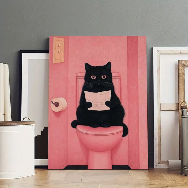 Funny black cat bathroom canvas art print showing cat reading newspaper on pink toilet - humorous wall decor.