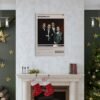 Goodfellas movie poster displayed above fireplace in elegant Christmas living room with green walls and holiday decorations.c