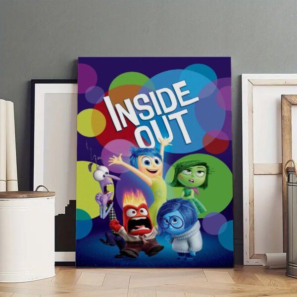 Large Inside Out movie poster displayed in artist studio with white frames and creative workspace setup.