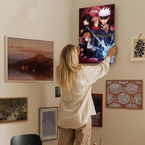 Person hanging Jujutsu Kaisen anime poster on gallery wall with mixed art collection in home interior.