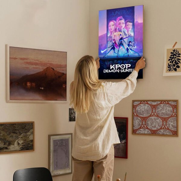 Woman hanging KPOP Demon Hunter canvas print on eclectic gallery wall for modern home decor styling