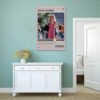 Legally Blonde movie poster displayed on sage green wall above white sideboard cabinet in modern coastal-style interior with natural fiber rug and minimalist decor.