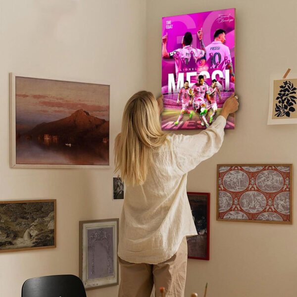 Woman hanging Messi GOAT canvas poster on elegant home gallery wall with curated art collection