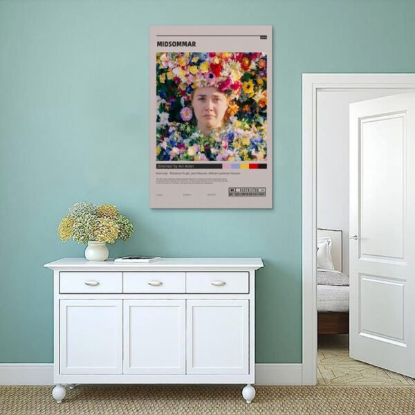 Midsommar movie poster displayed on mint green wall above white vintage sideboard with brass handles and decorative dried flowers in minimalist bedroom setting.
