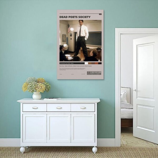 Dead Poets Society movie poster displayed on mint green wall above white sideboard in minimalist Scandinavian-style home interior with fresh flowers and modern decor.