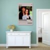 Heathers movie poster displayed above white vintage sideboard in mint green minimalist bedroom with dried flower decor.