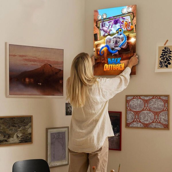 Person hanging Back to the Outback movie poster on gallery wall showcasing movie poster home decor ideas and interior design inspiration.