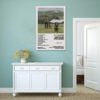 Noah Kahan Stick Season album poster displayed in mint green coastal bedroom with white furniture and natural textures