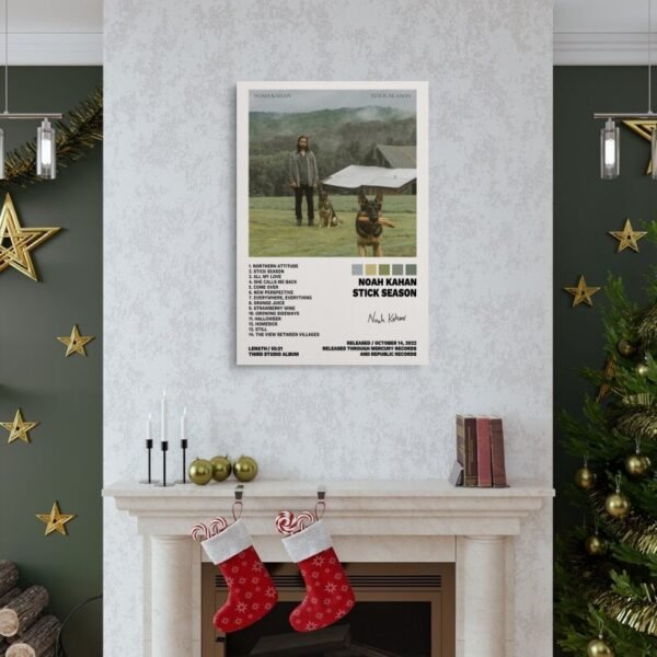 Noah Kahan Stick Season album poster displayed above Christmas fireplace with holiday decorations and green accent walls