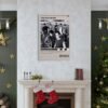 The Outsiders movie poster displayed above fireplace mantel in Christmas decorated living room with holiday decor