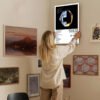 Person hanging Daft Punk Random Access Memories poster on gallery wall with mixed art collection for home decor inspiration