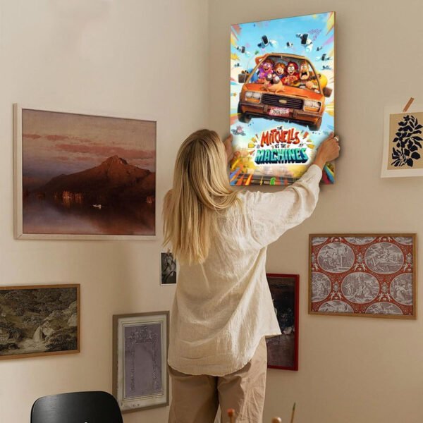 Person hanging The Mitchells vs The Machines canvas poster on gallery wall showing movie art home decor styling.