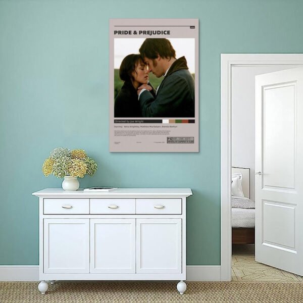 Pride and Prejudice movie poster displayed as modern wall art in mint green coastal-style room above white sideboard with dried flower arrangement.