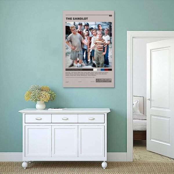 The Sandlot movie poster displayed on sage green wall above white sideboard in modern coastal style interior design