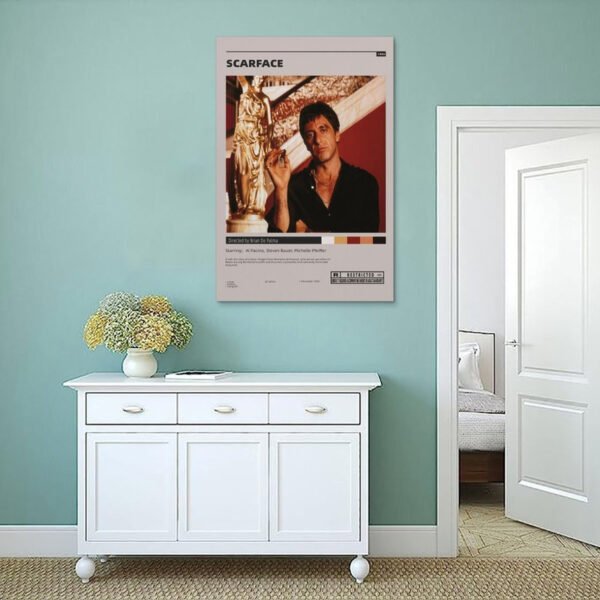 Scarface movie poster displayed on sage green wall above white vintage sideboard in minimalist coastal-style interior design.