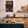The Kanye West comic book canvas print hanging on a white tiled wall in a modern kitchen with natural wood cabinets. The art adds a pop of color and personality above the dining area.