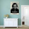 The Shining movie poster displayed on sage green wall above white console cabinet in coastal style interior