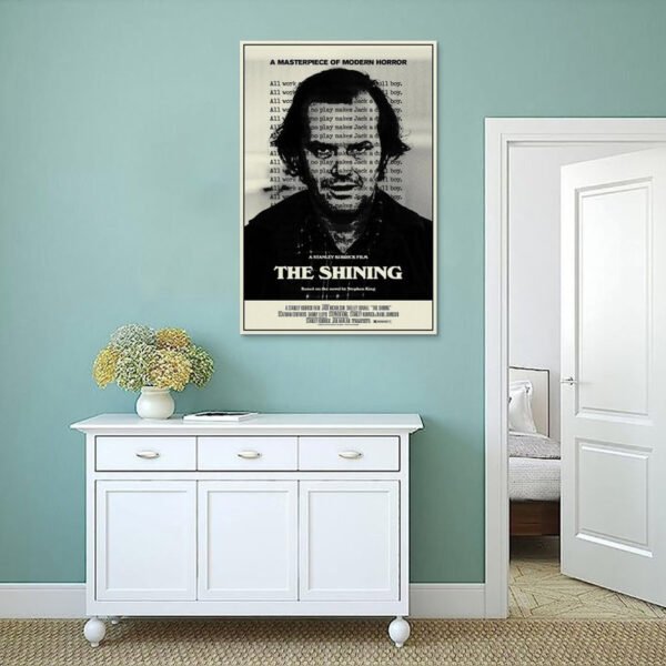 The Shining movie poster displayed on sage green wall above white console cabinet in coastal style interior