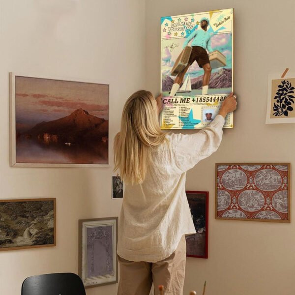 Person hanging Tyler The Creator Call Me If You Get Lost Estate Sale poster on gallery wall with vintage art collection for home decor styling