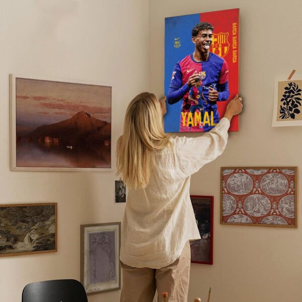 Woman hanging Lamine Yamal Barcelona canvas print on gallery wall in modern living room with eclectic art collection